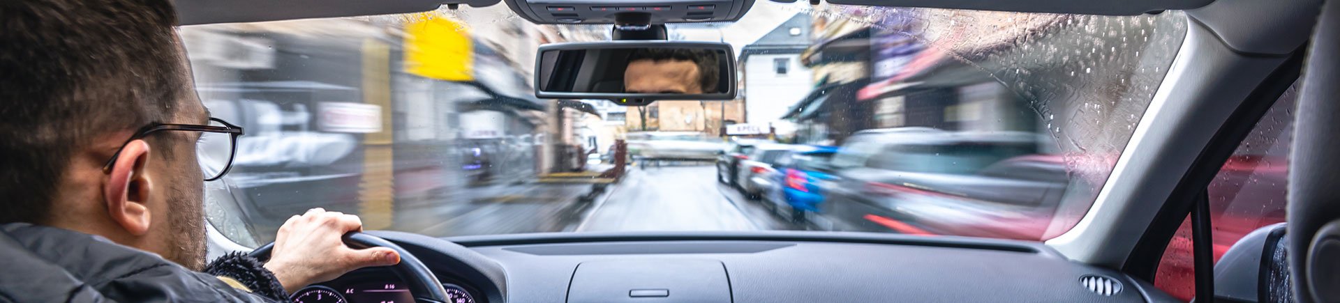 Driver at the wheel in city traffic